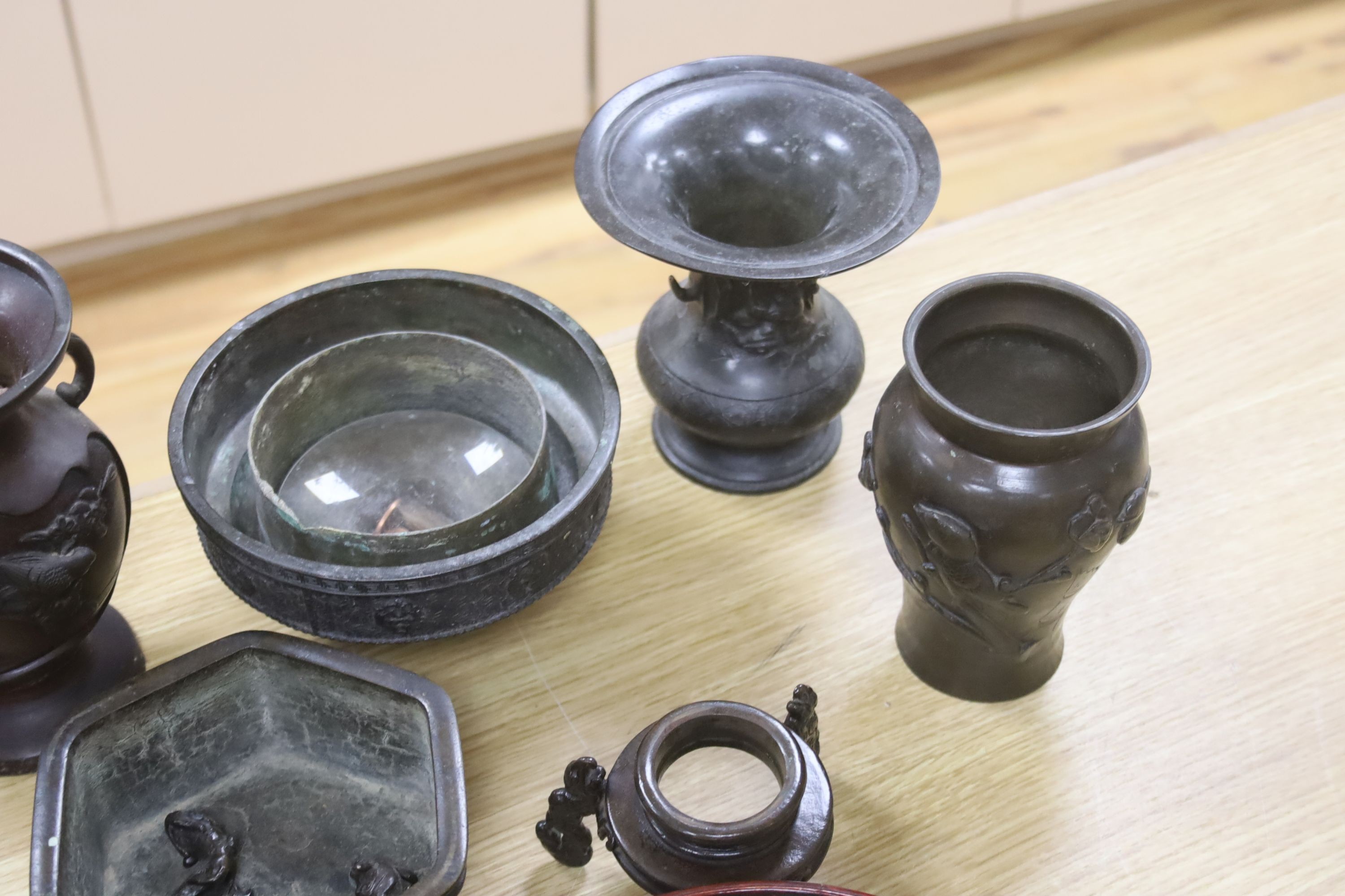 A group of Japanese bronze vases and sundry hardwood stands